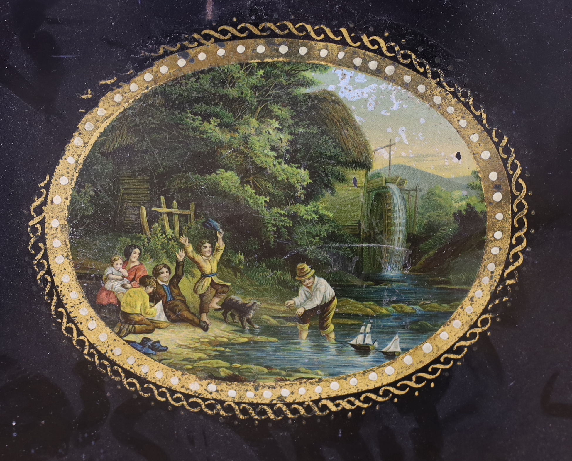 A Victorian toleware tray with transfer cartouche of children playing with model boats, width 60cm